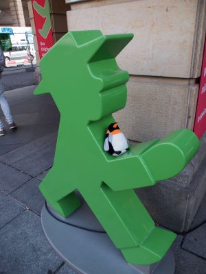 penguin sitting on statue