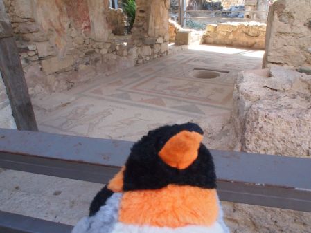 penguin in front of mosaic