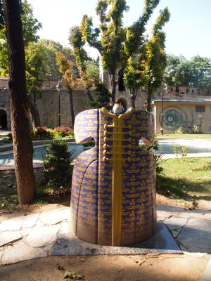 penguin sitting on dress statue