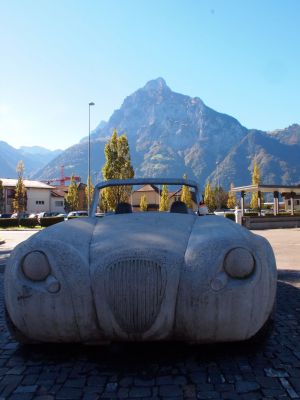 penguin sitting on car statue