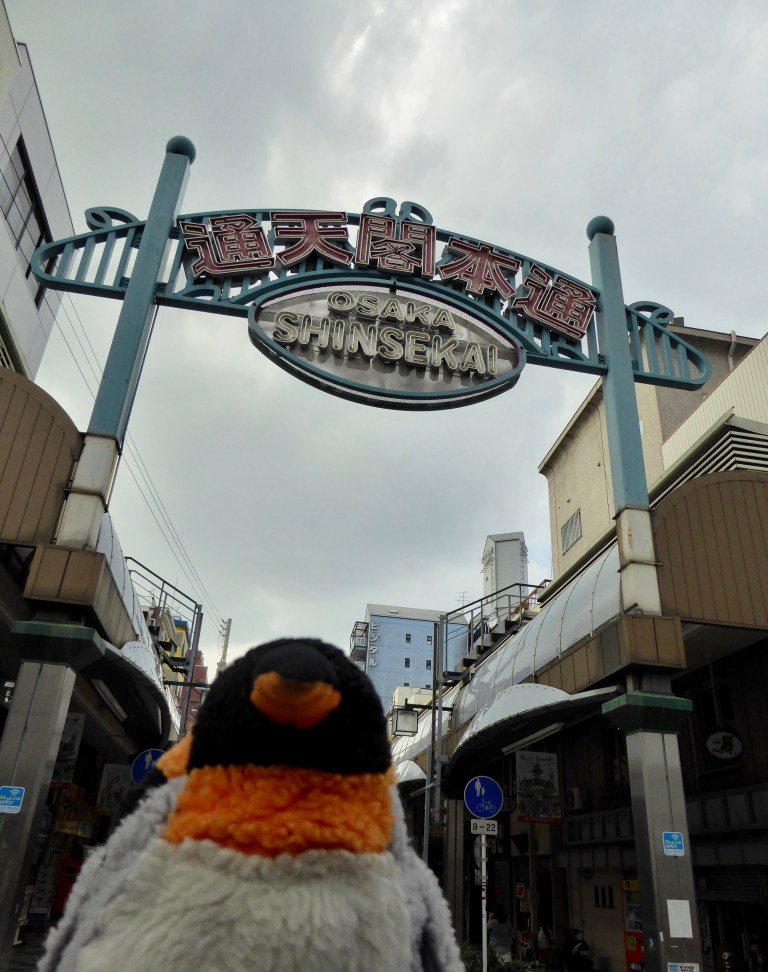 penguin in front of sign