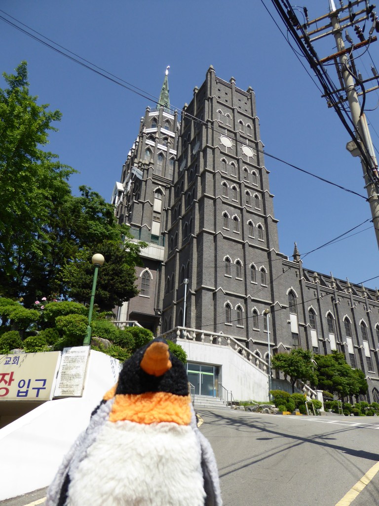 Penguin in front of cathedral