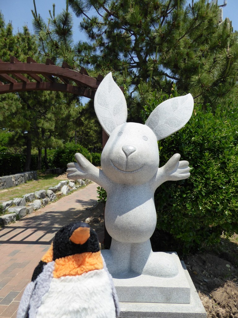 penguin with rabbit statue