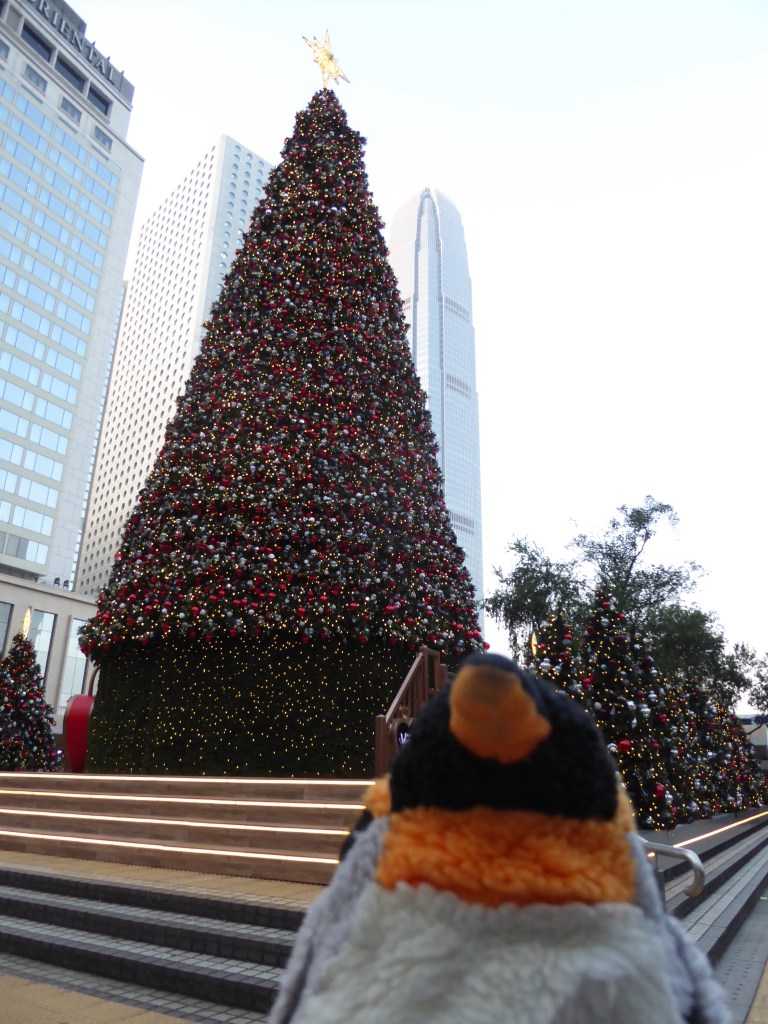 penguin in front of Christmas tree