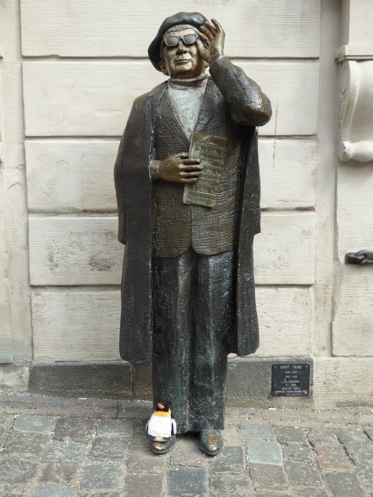 penguin sitting on statue