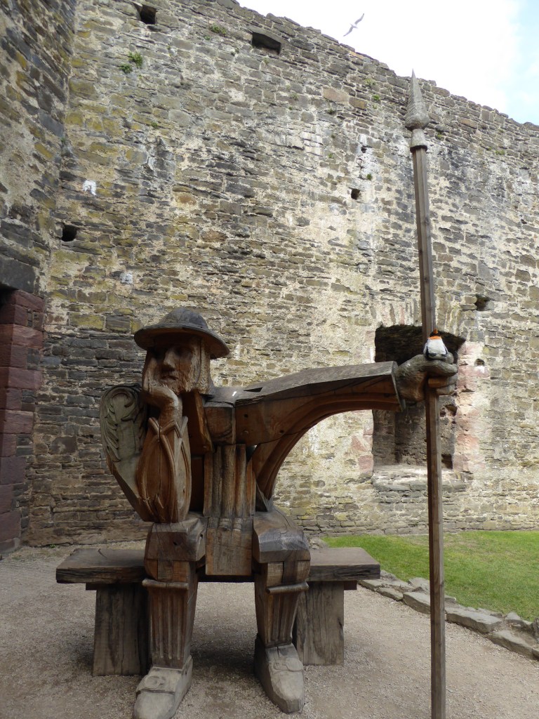 penguin sitting on wooden man